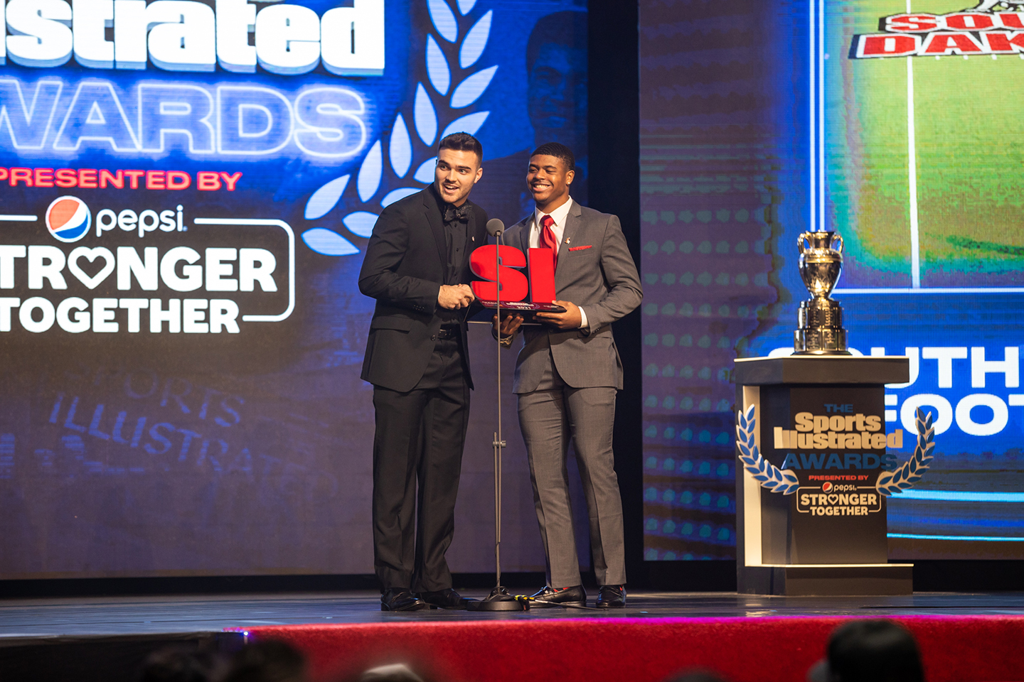 USD football accepts Sports Illustrated Award